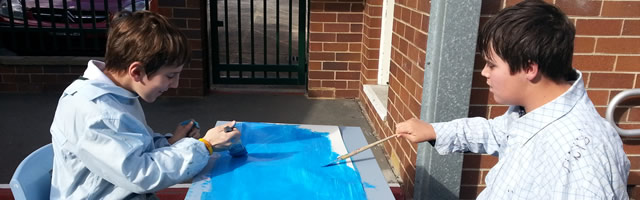 Two students painting together