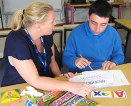 Teacher helping a student with literacy work
