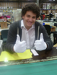 Student smiling with his thumbs up
